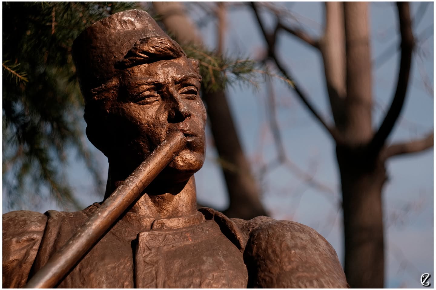 The flute player statue on Pogradec's lakefront promenade — a symbol of the city's musical heritage